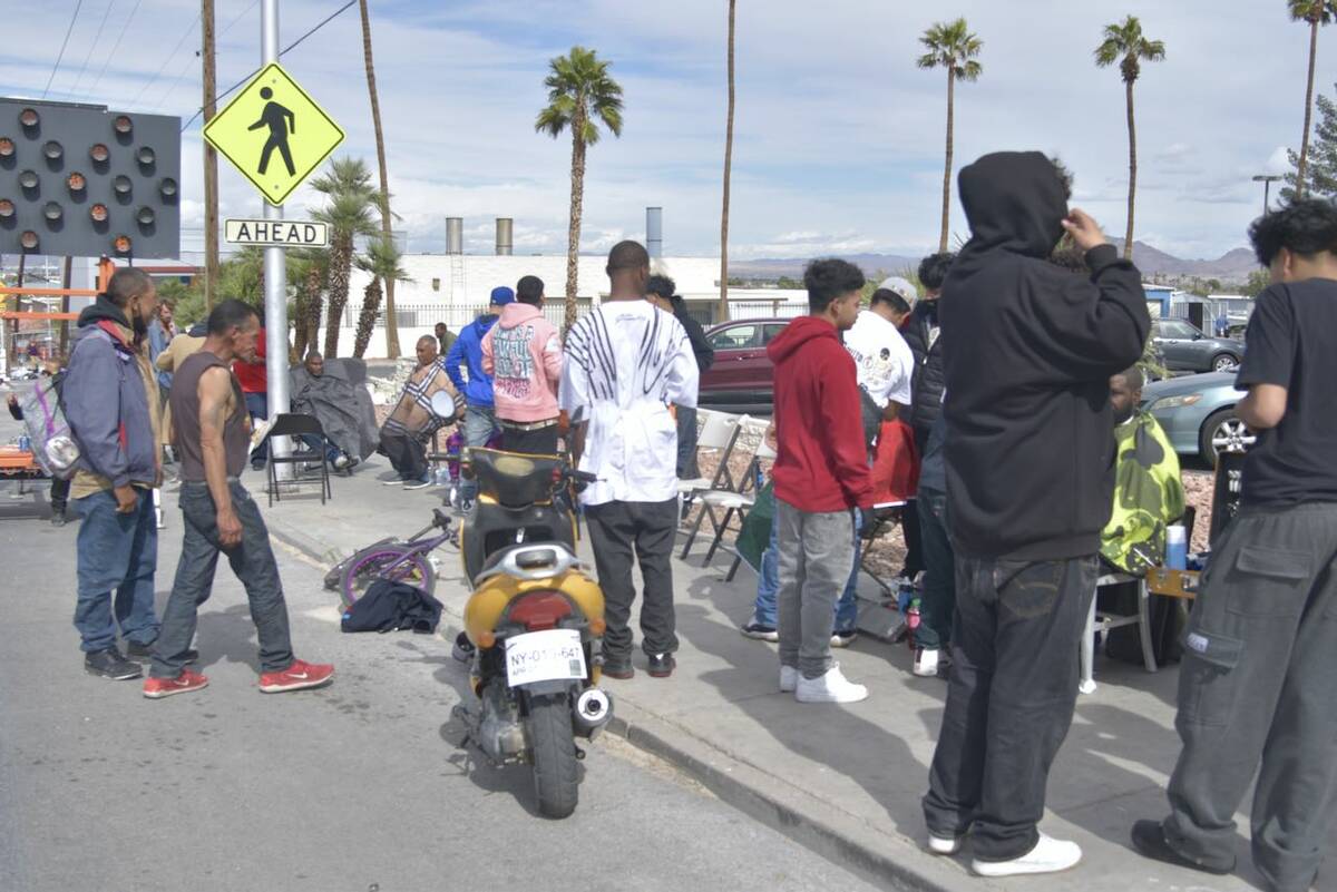 A crowd forms for free haircuts and food near Main Street and Owens Avenue on Saturday, March 1 ...