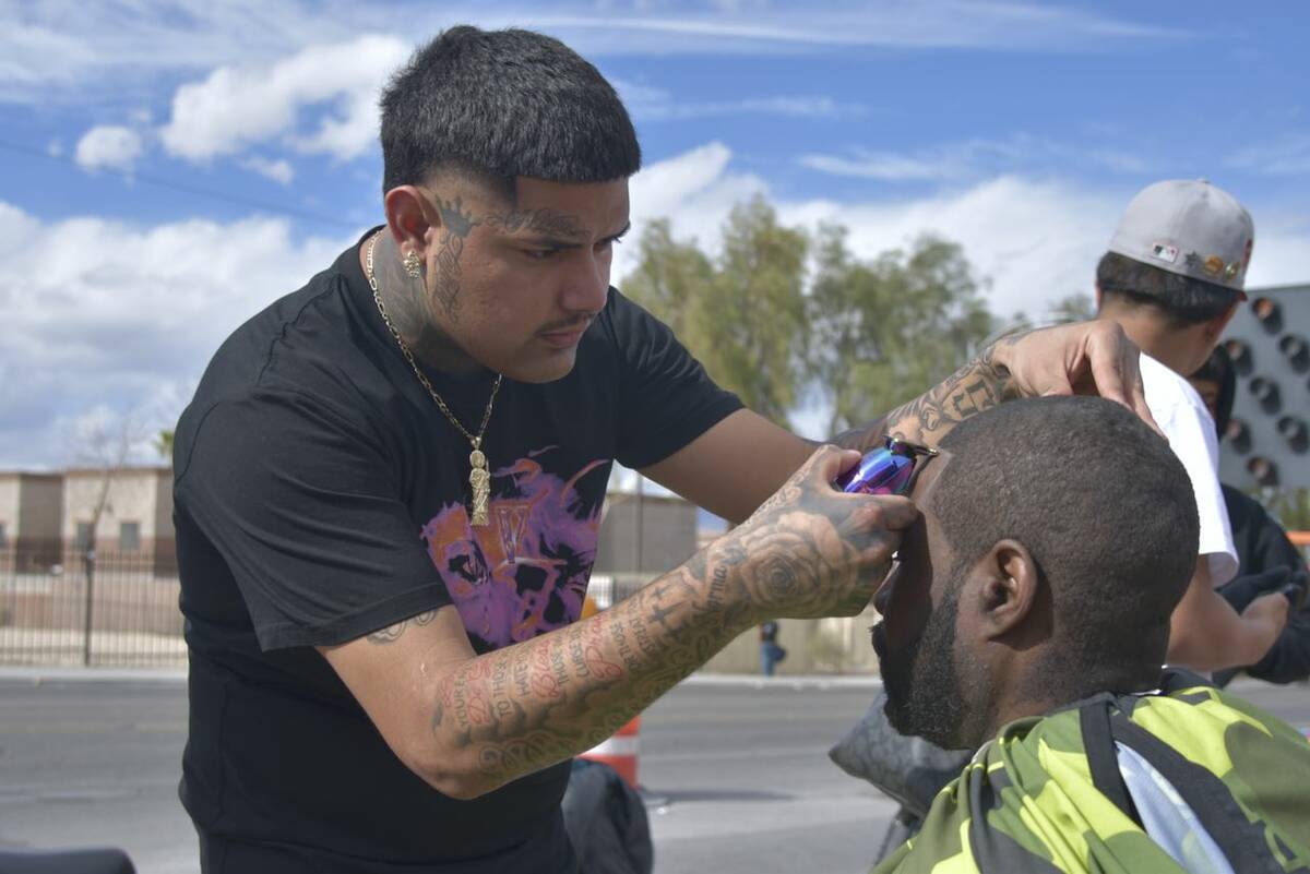 Christopher Ramirez, left, gives Junis Davis, right, a line up on the sidewalk near Main Street ...