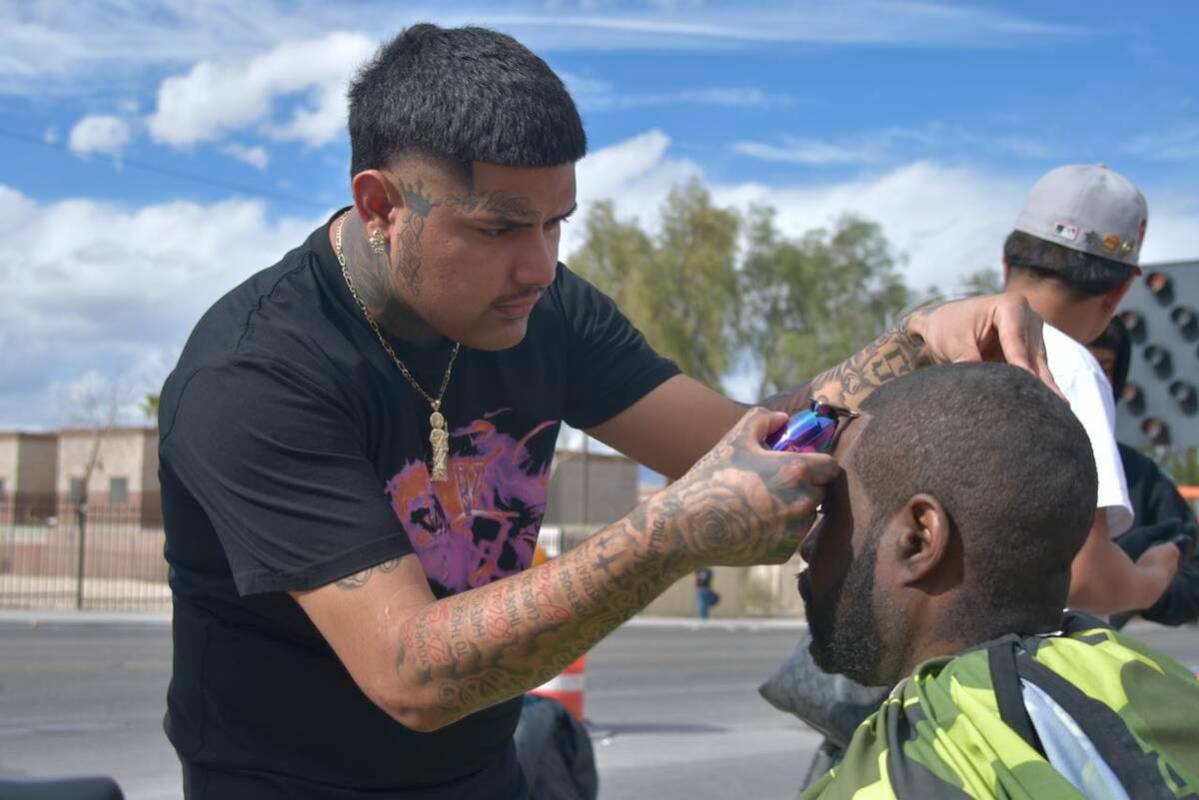 Christopher Ramirez, left, gives Junis Davis, right, a line up on the sidewalk near Main Street ...