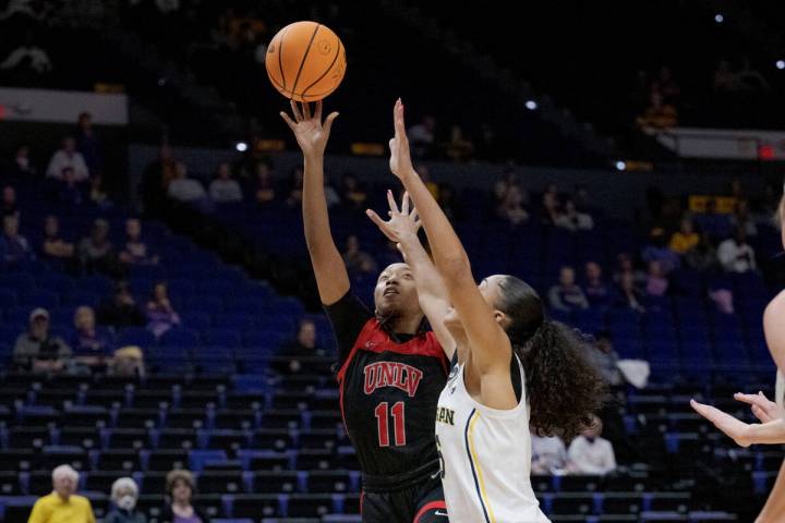 UNLV guard Justice Ethridge (11) shoots against Michigan guard Laila Phelia, right, in the firs ...