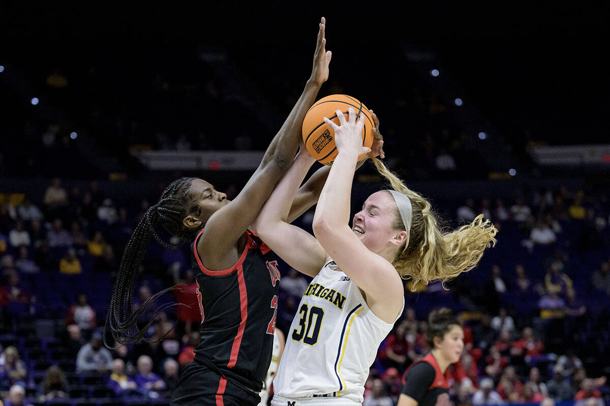 Michigan guard Elise Stuck (30) shoots against UNLV center Desi-Rae Young, left, in the second ...