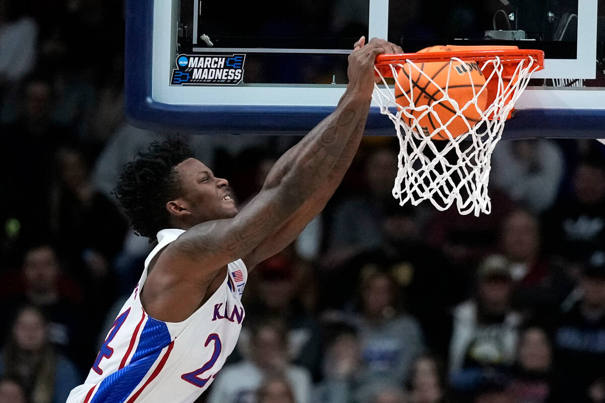 Kansas forward K.J. Adams Jr. dunks the ball in the first half of a second-round college basket ...