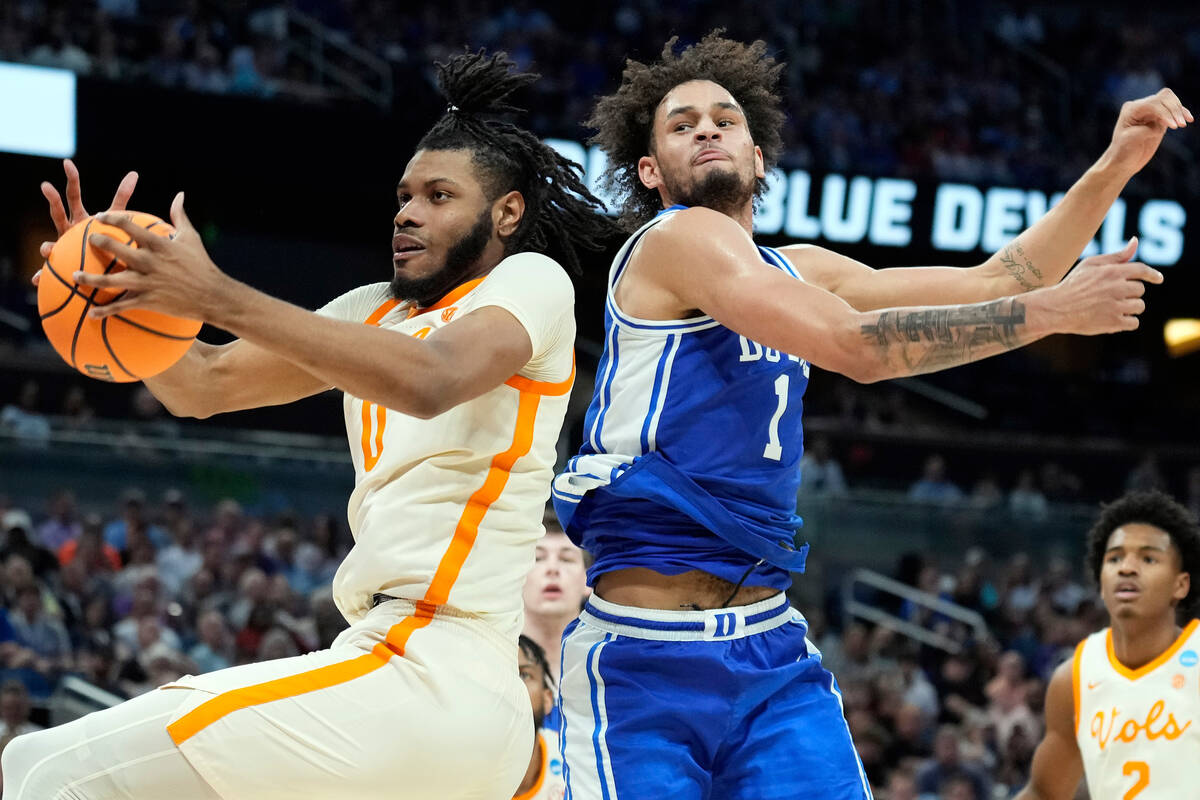 Tennessee forward Jonas Aidoo (0) takes a rebound away from Duke center Dereck Lively II (1) du ...