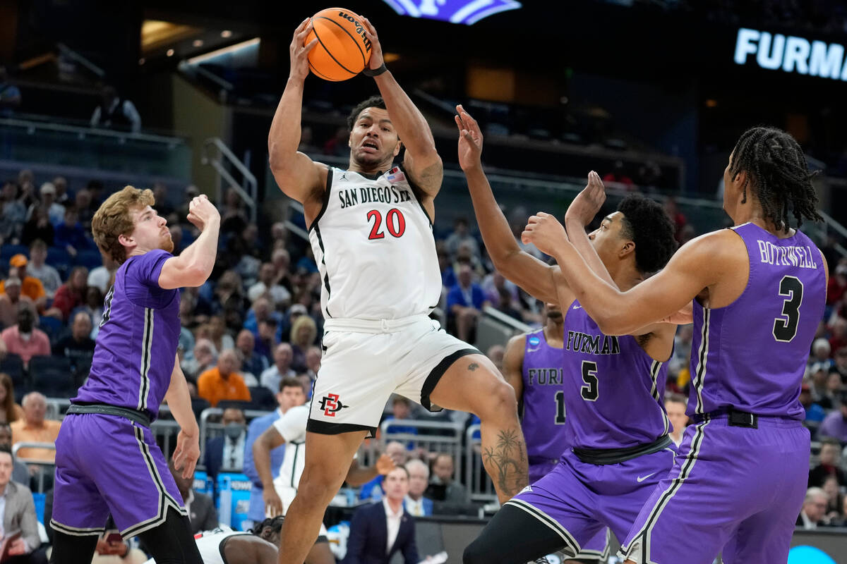 San Diego State guard Matt Bradley (20) grabs a rebound away from Furman forward Garrett Hien ( ...