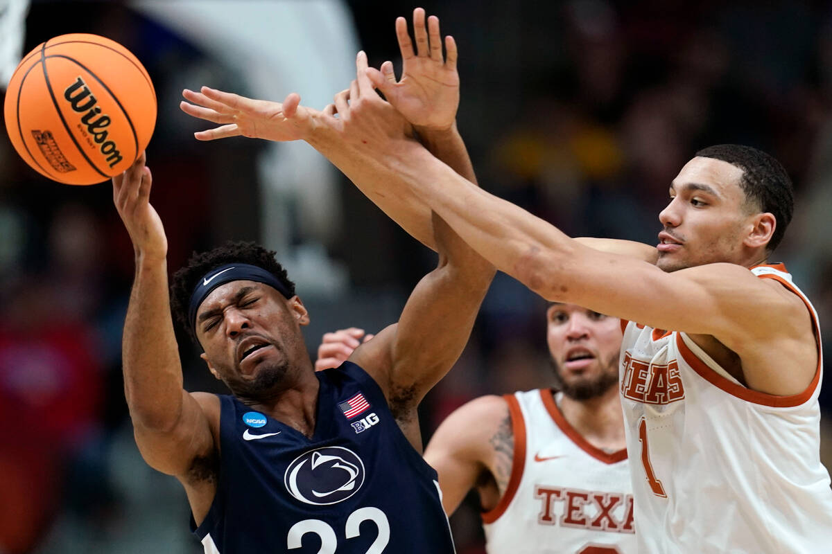 Penn State guard Jalen Pickett (22) is fouled by Texas forward Dylan Disu (1) in the first half ...