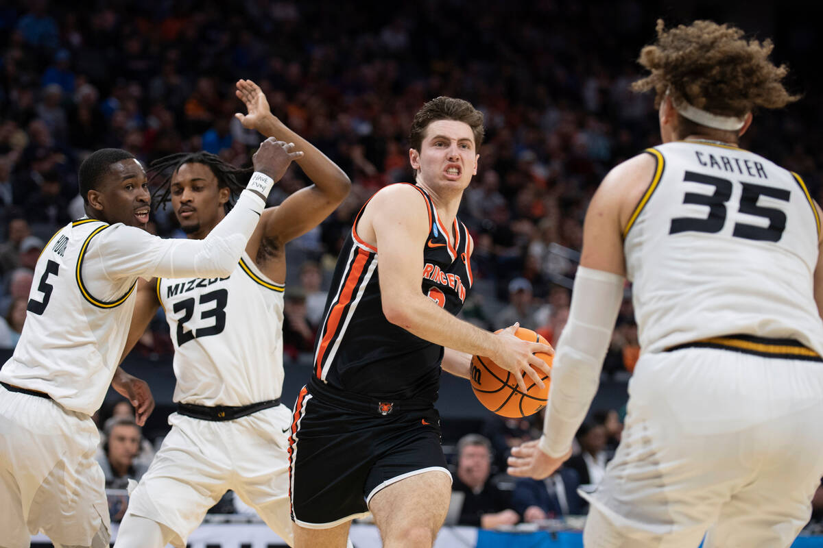 Princeton guard Ryan Langborg (3) gets past Missouri guard D'Moi Hodge (5) and forward Aidan Sh ...