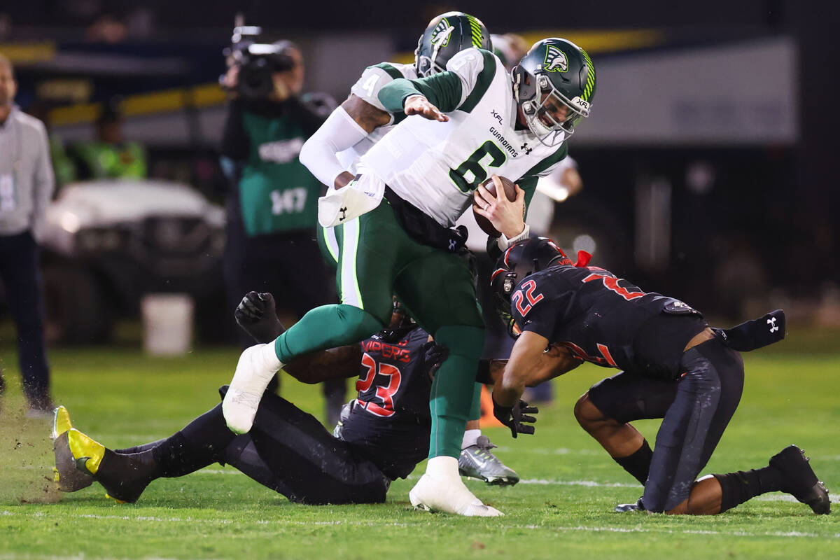 Vegas Vipers defensive back Adam Sparks (22) and outside linebacker Max Roberts (23) tackle Orl ...