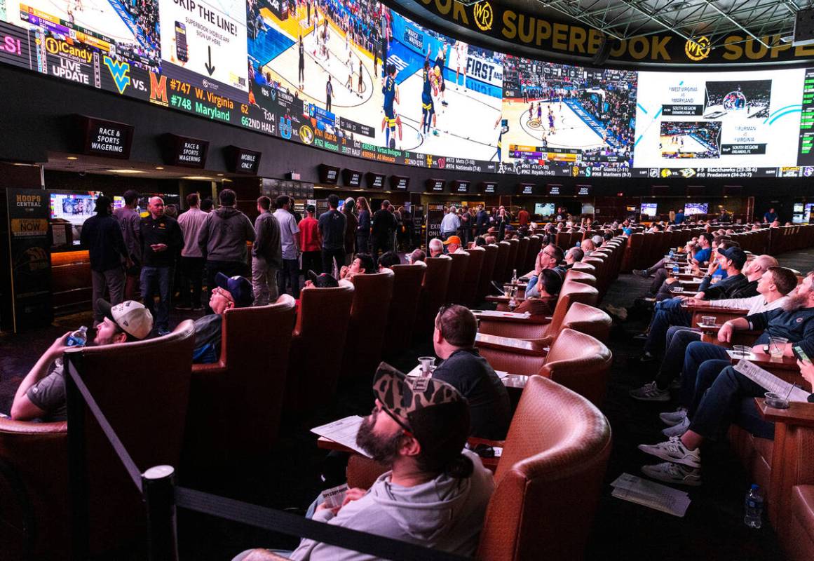 Guests watch on the big screens the first day of the NCAA basketball tournament at the Westgate ...