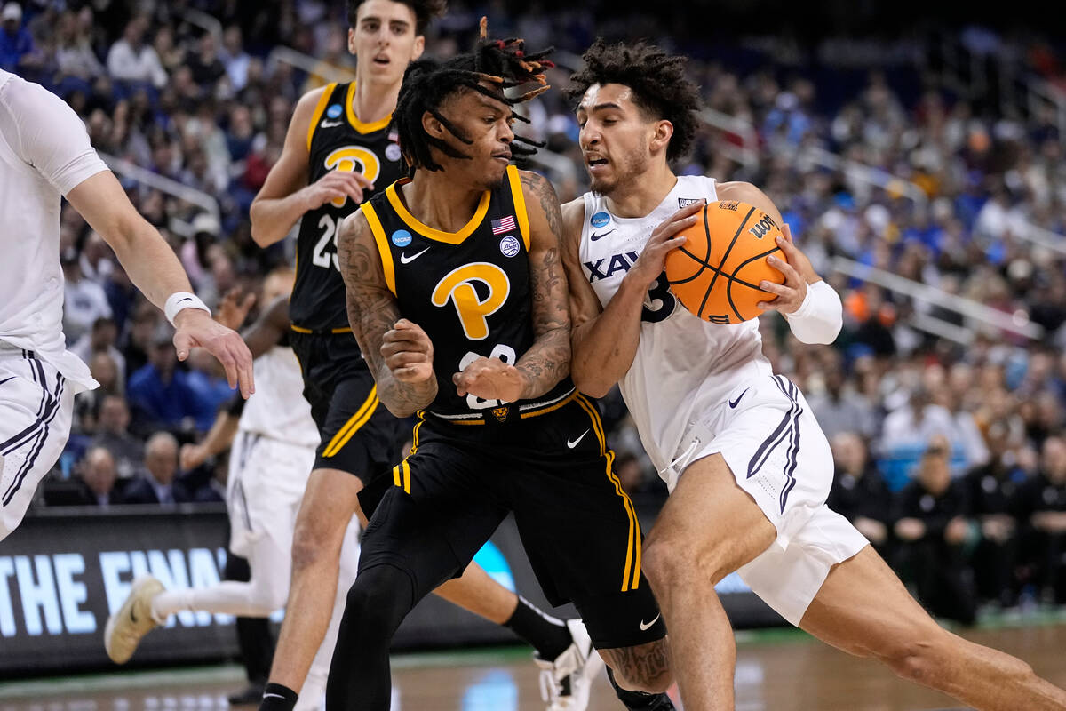 Xavier guard Colby Jones (3) drives against Pittsburgh guard Nike Sibande (22)during the first ...