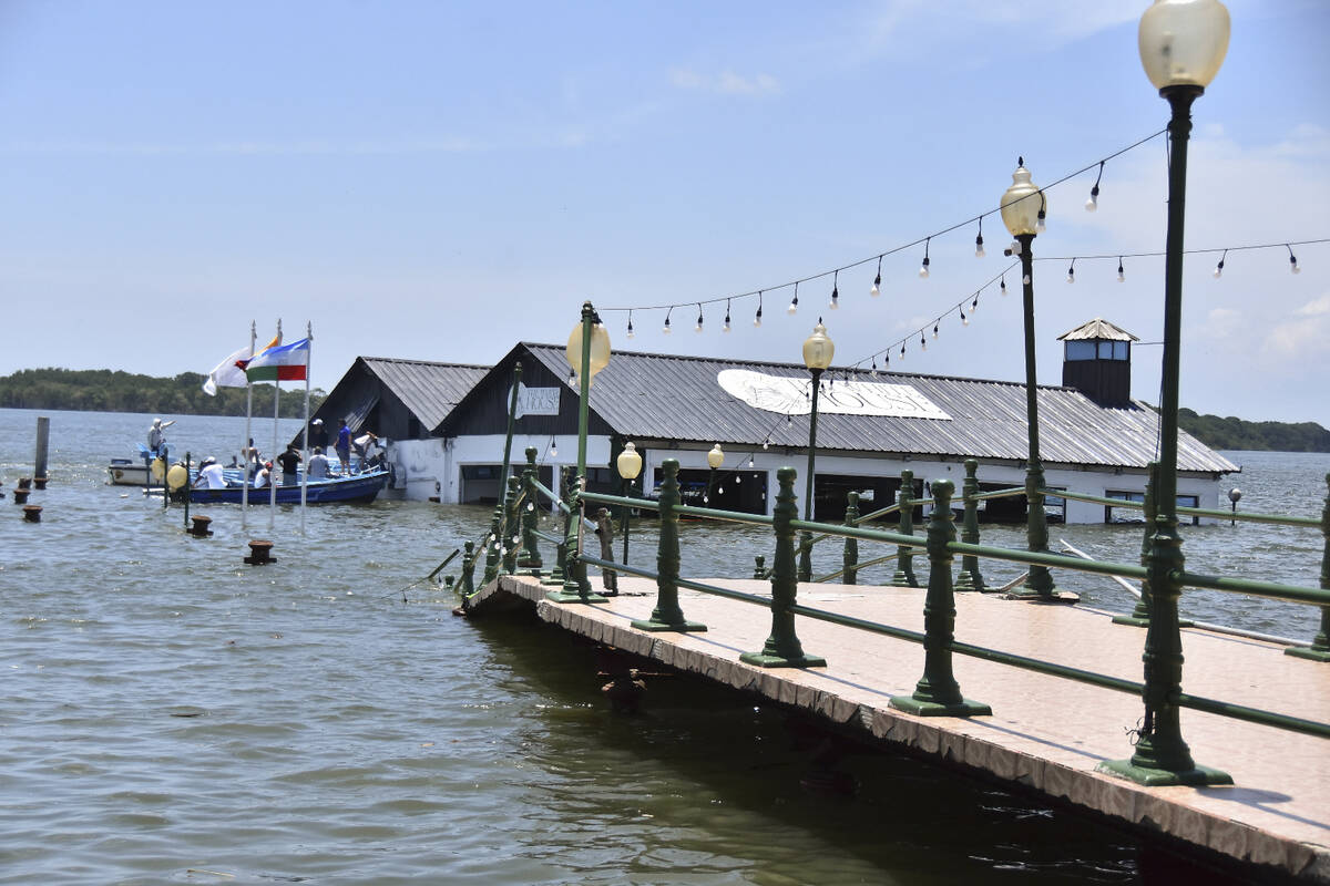 The Marine Museum of Puerto Bolivar, detached from the dock, is partially inundated in water af ...