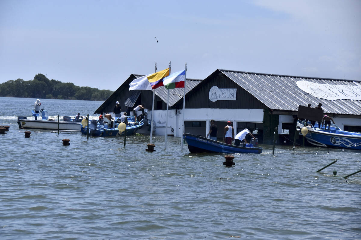 The Marine Museum of Puerto Bolivar, detached from the dock, is partially inundated in water af ...