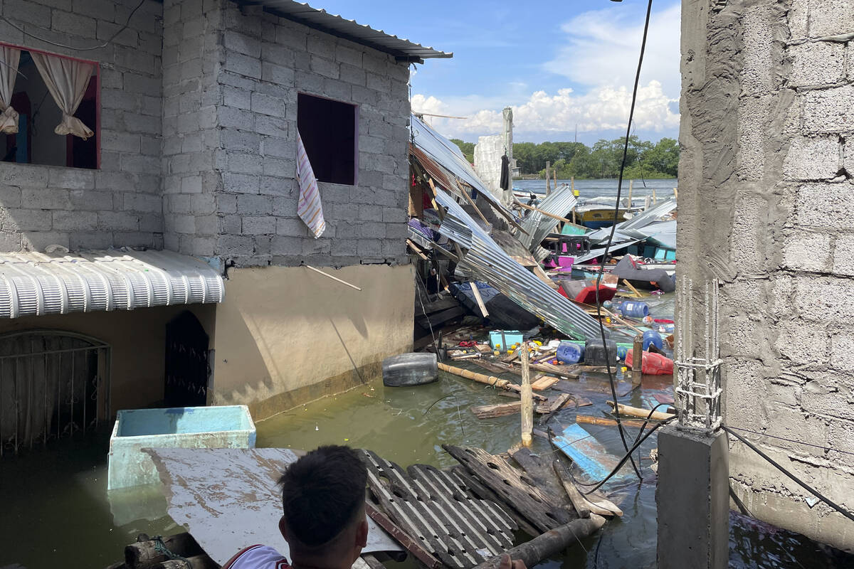 Household belongings float in water after an earthquake shook Machala, Ecuador, Saturday, March ...