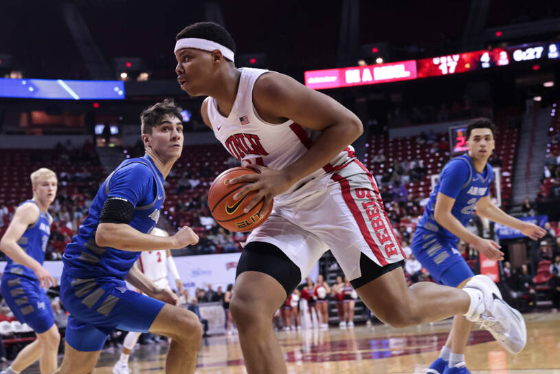 UNLV guard Keyshawn Hall, right, drives the ball around Air Force Falcons forward Beau Becker ( ...