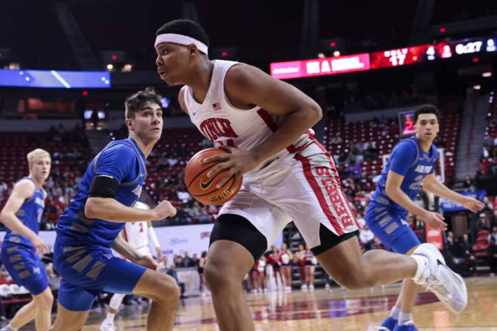 UNLV guard Keyshawn Hall, right, drives the ball around Air Force Falcons forward Beau Becker ( ...