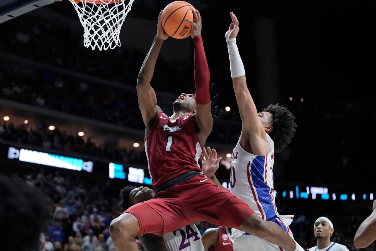 Arkansas' Ricky Council IV is fouled by =tk10 during the final second of second half of a secon ...