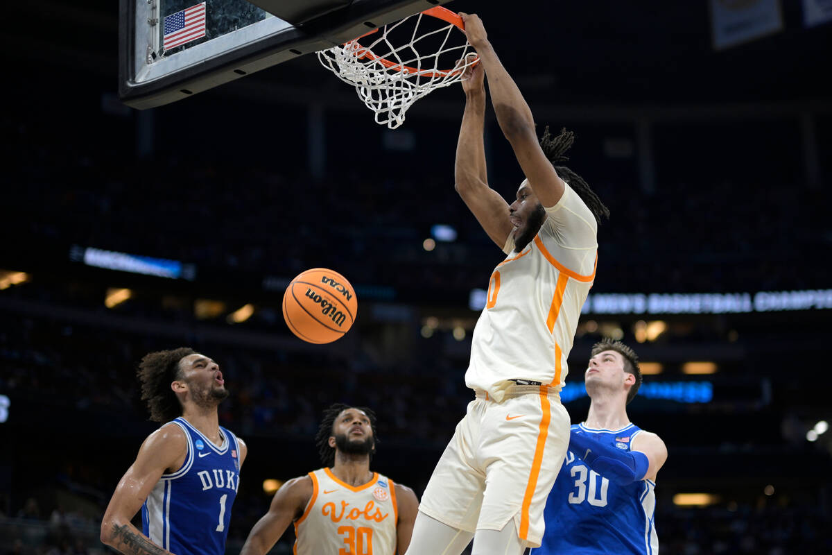 Tennessee forward Jonas Aidoo (0) dunks as guard Josiah-Jordan James (30) and Duke center Derec ...