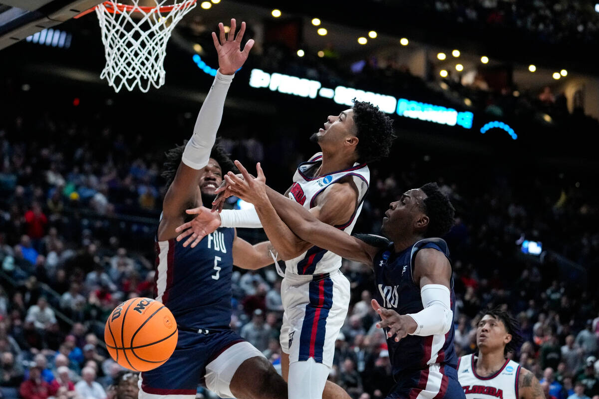 Florida Atlantic guard Nicholas Boyd (2) is fouled between Fairleigh Dickinson forward Ansley A ...