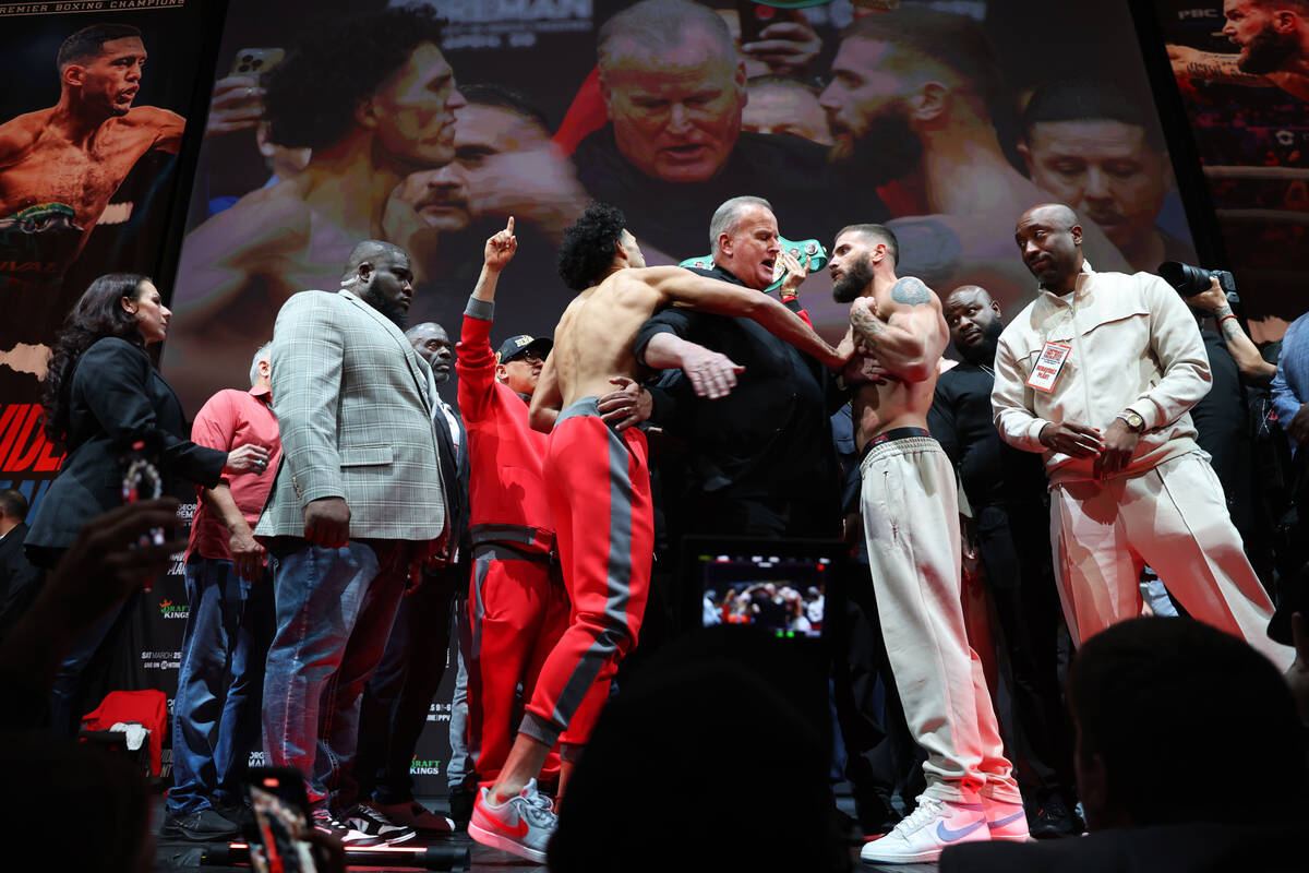 David Benavidez, left, and Caleb Plant, face off during a weigh-in event in advance of their su ...