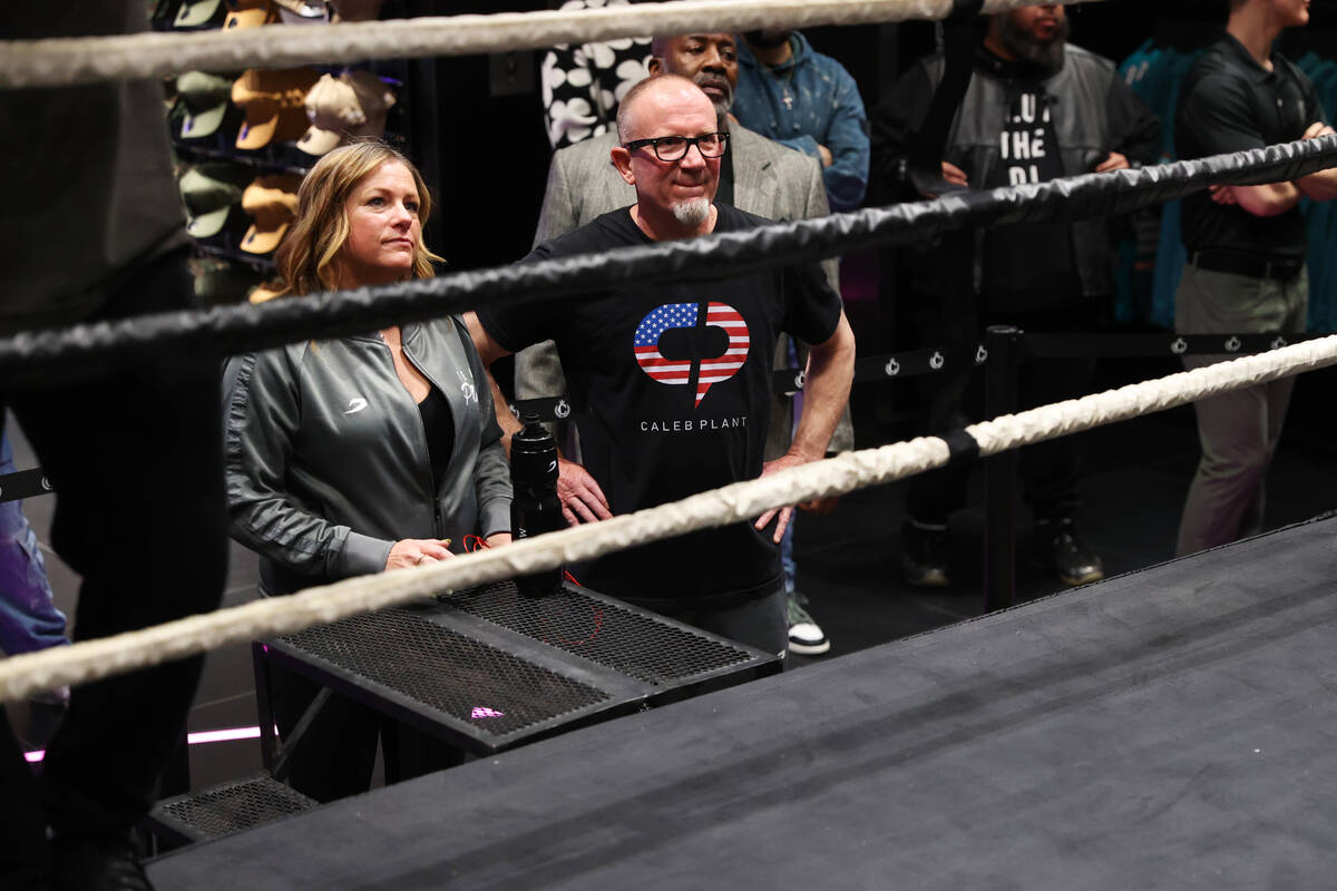 Richie Plant, center, watches his son Caleb Plant, on the boxing ring during a media workout at ...