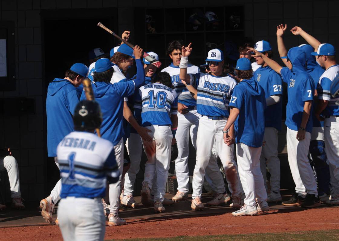 Basic players celebrate a run by Troy Southisene (10) during a baseball game against Green Vall ...