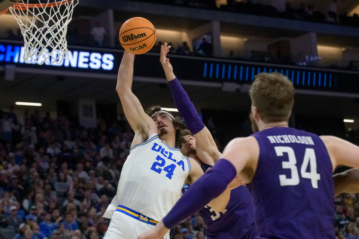 UCLA guard Jaime Jaquez Jr. (24) and Northwestern forward Robbie Beran vie for a rebound during ...