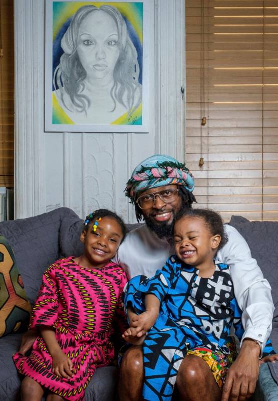 In this photo provided by Henry Danner, Omari Maynard sits with his children, Anari, left, and ...