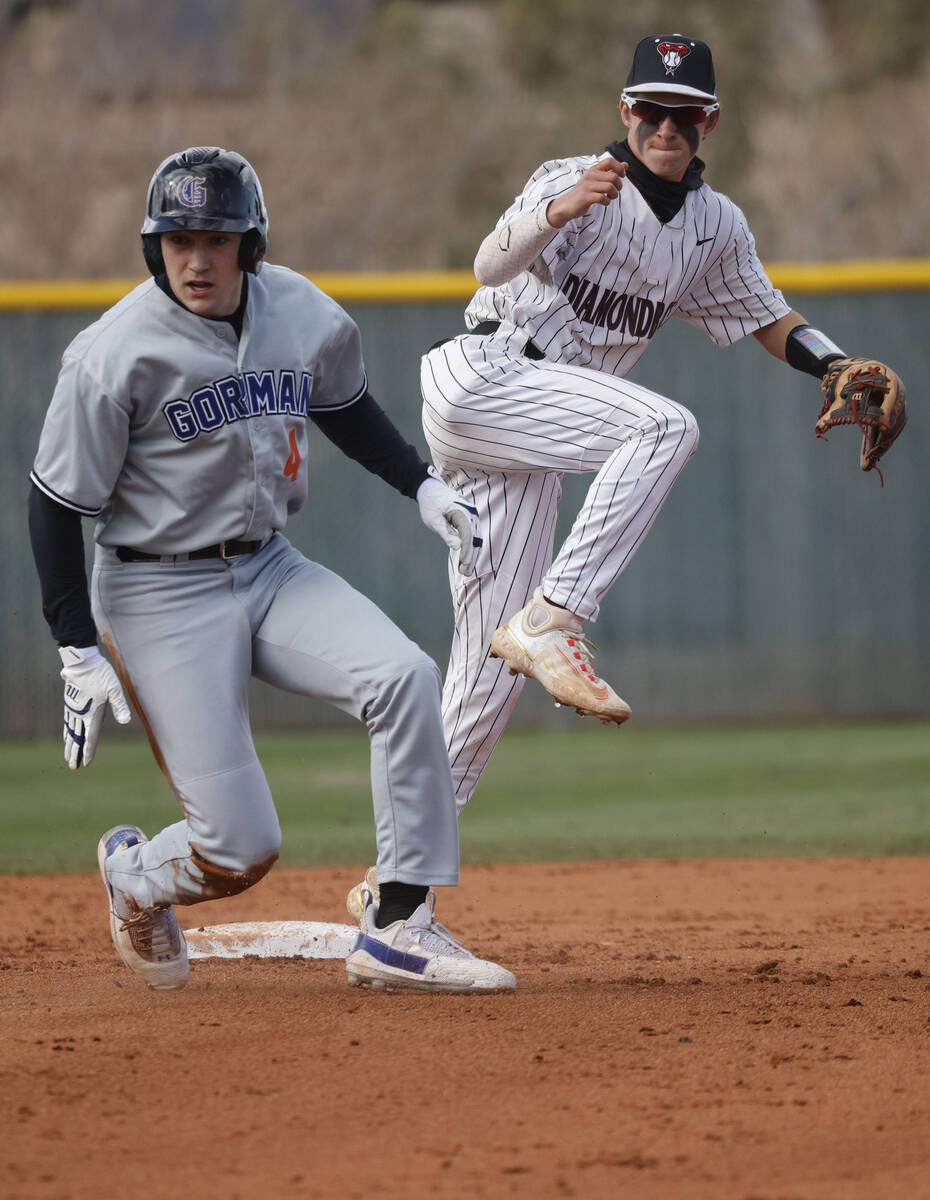 Desert Oasis' Connor Jacob (8) throws to first for a double play after forcing out Bishop Gorma ...