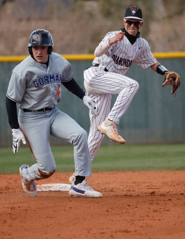 Desert Oasis' Connor Jacob (8) throws to first for a double play after forcing out Bishop Gorma ...