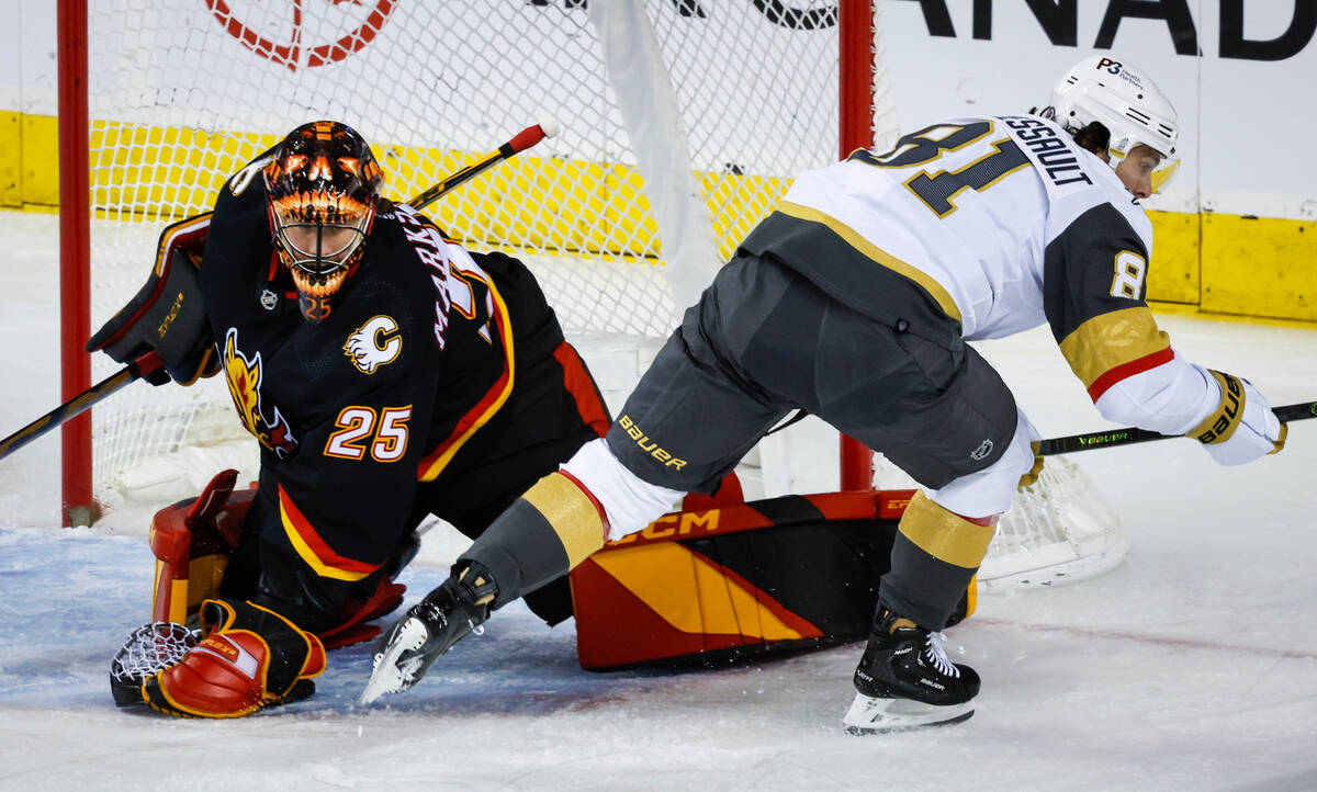 Vegas Golden Knights forward Jonathan Marchessault, right, has his shot grabbed by Calgary Flam ...