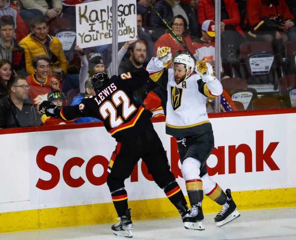 Vegas Golden Knights defenseman Alex Pietrangelo, right, checks Calgary Flames forward Trevor L ...