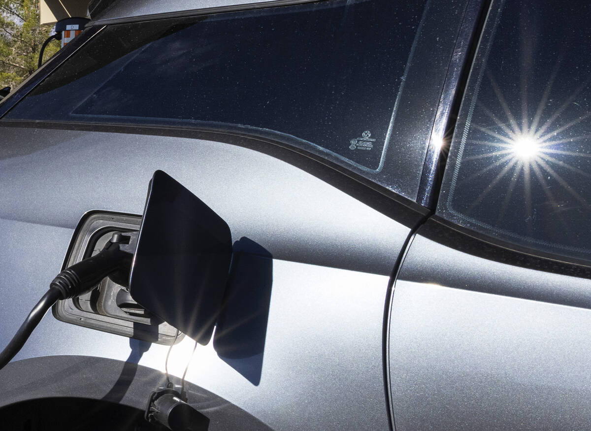 An electric vehicle get its battery recharged in the parking lot of NV Energy's headquarters at ...