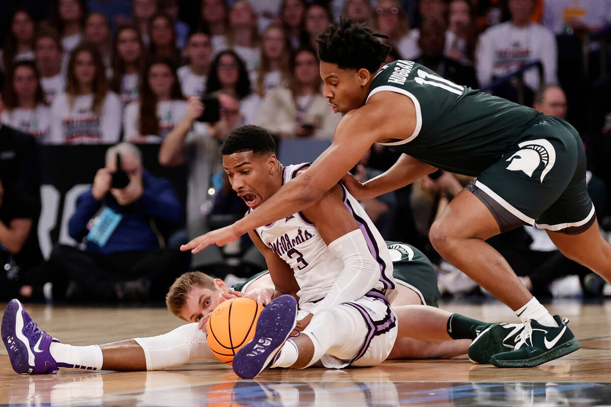 Kansas State forward David N'Guessan (3) and Michigan State guard A.J. Hoggard (11) reach for t ...