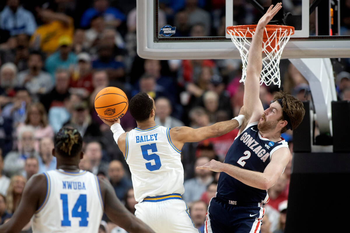 UCLA Bruins guard Amari Bailey (5) shoots against Gonzaga Bulldogs forward Drew Timme (2) while ...