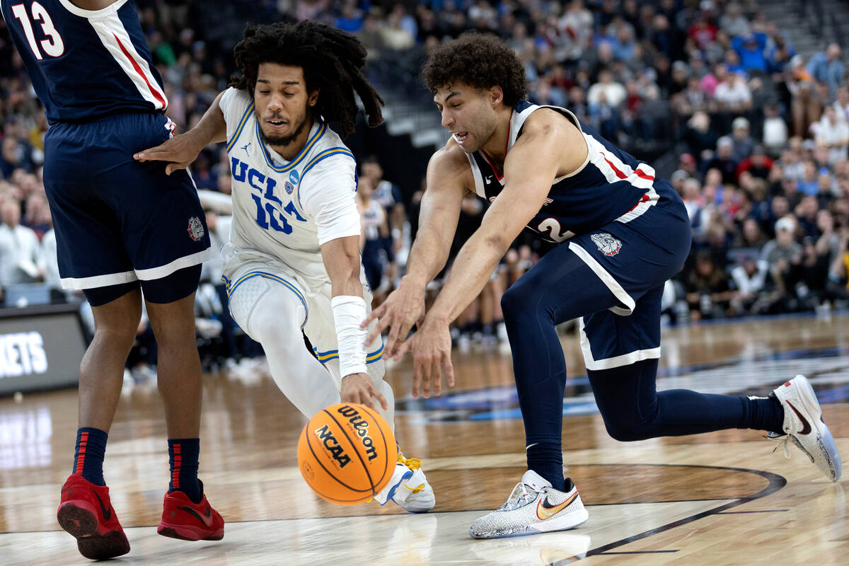 UCLA Bruins guard Tyger Campbell (10) dribbles around Gonzaga Bulldogs guard Malachi Smith (13) ...