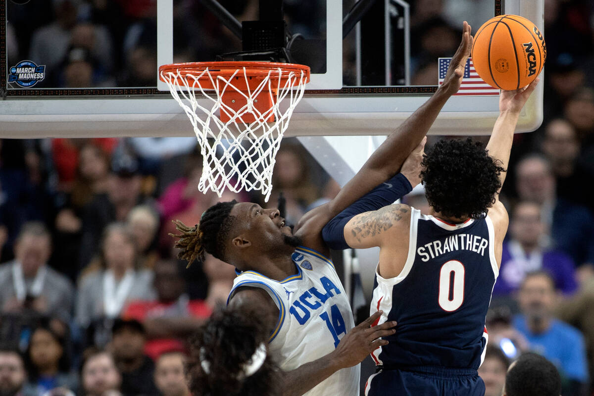 Gonzaga Bulldogs guard Julian Strawther (0) shoots against UCLA Bruins forward Kenneth Nwuba (1 ...