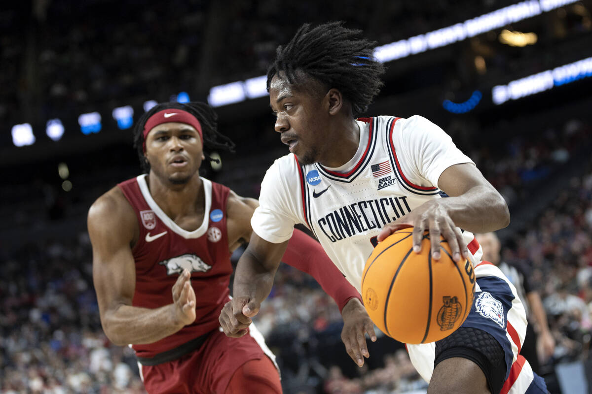 Connecticut Huskies guard Tristen Newton (2) drives around Arkansas Razorbacks guard Ricky Coun ...