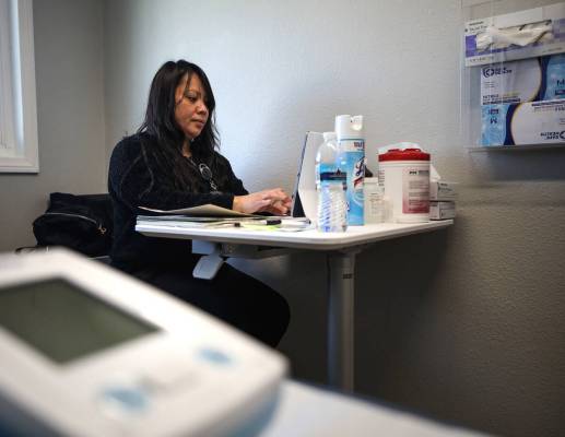 Rose Manalo, medical assistant, works in a patient room at The Neighborhood Clinic inside the s ...