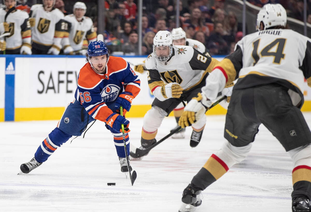 Vegas Golden Knights' Zach Whitecloud (2) and Nicolas Hague (14) chase Edmonton Oilers' Kailer ...