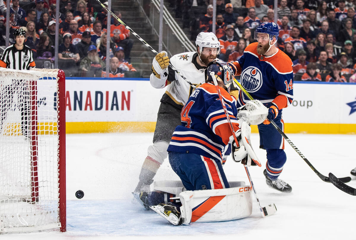 Vegas Golden Knights' Phil Kessel (8) works against Edmonton Oilers' Mattias Ekholm (14) as the ...