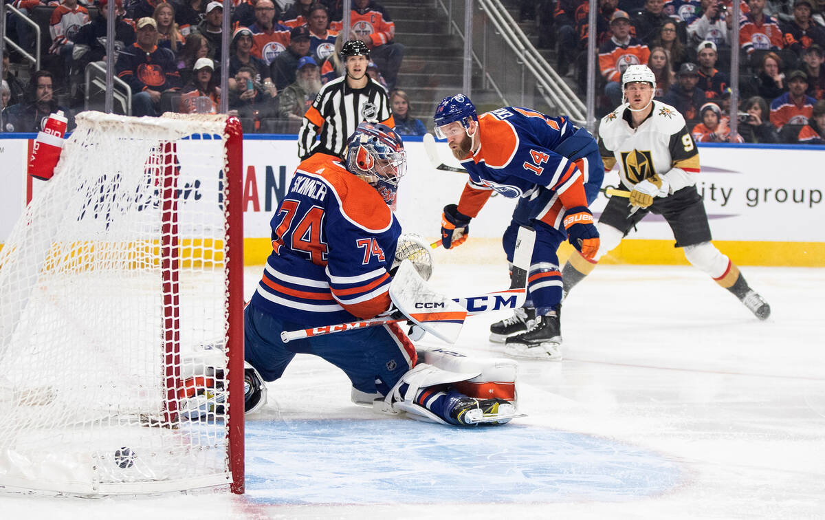 Vegas Golden Knights' Jack Eichel (9) scores on Edmonton Oilers goalie Stuart Skinner (74) as M ...