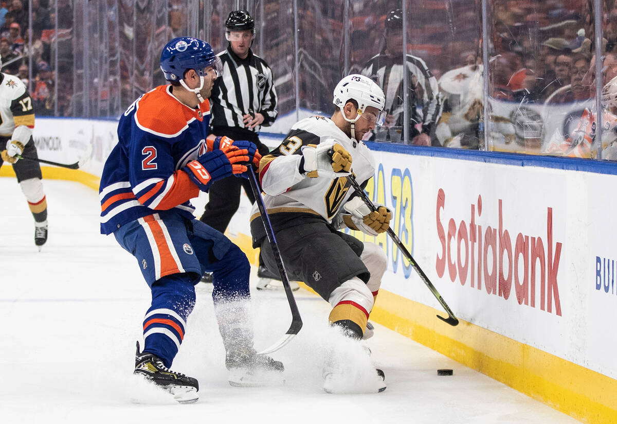 Vegas Golden Knights' Teddy Blueger (53) and Edmonton Oilers' Evan Bouchard (2) vie for the puc ...