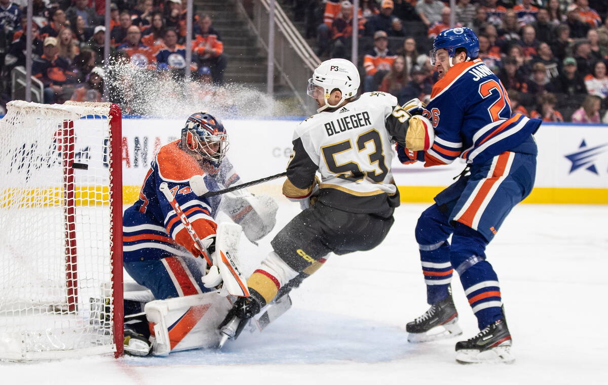 Vegas Golden Knights' Teddy Blueger (53) is stopped by Edmonton Oilers goalie Stuart Skinner (7 ...