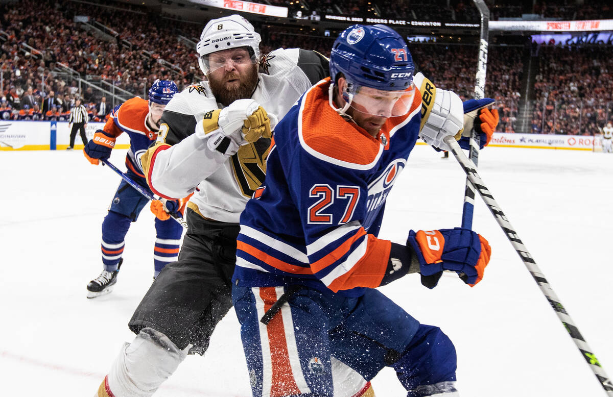 Vegas Golden Knights' Phil Kessel (8) and Edmonton Oilers' Brett Kulak (27) vie for the puck du ...