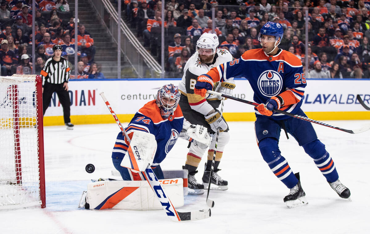 Vegas Golden Knights' Phil Kessel (8) and Edmonton Oilers' Darnell Nurse (25) and goalie Stuart ...