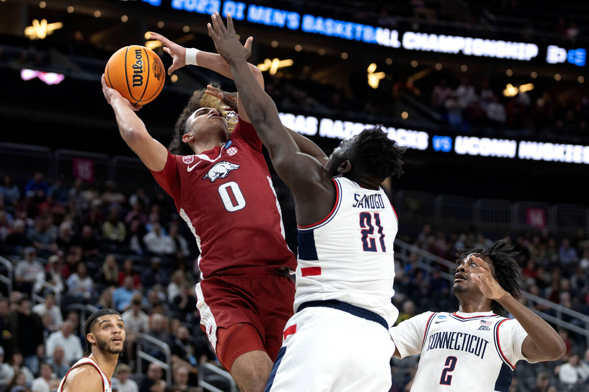 Arkansas Razorbacks guard Anthony Black (0) shoots against Connecticut Huskies forward Adama Sa ...