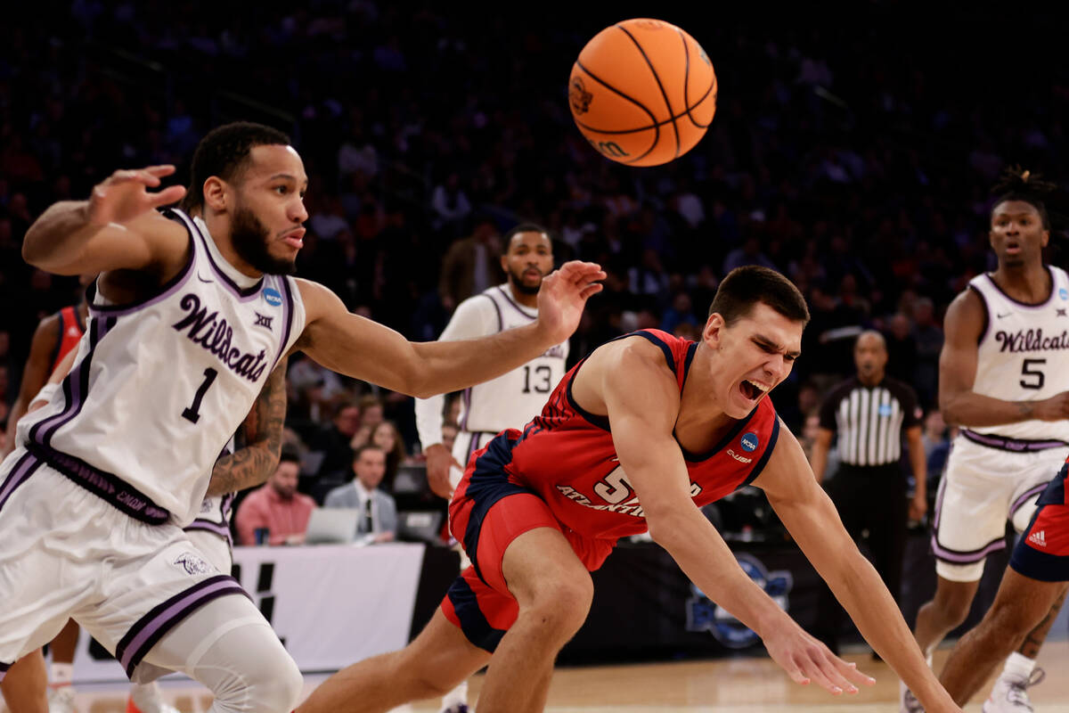 Kansas State's Markquis Nowell (1) and Florida Atlantic's Vladislav Goldin (50) battle for a re ...