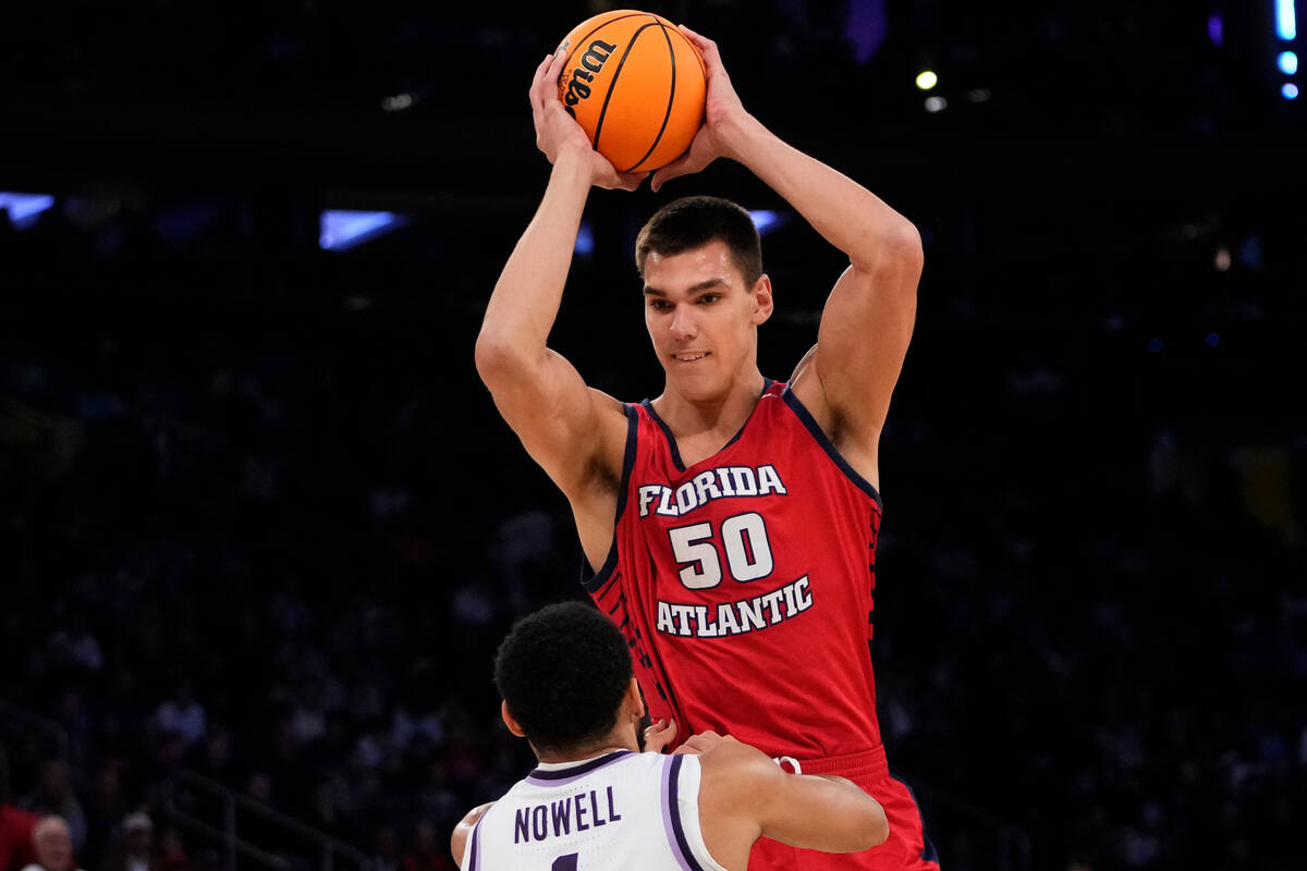 Florida Atlantic's Vladislav Goldin (50) grabs a rebound over Kansas State's Markquis Nowell (1 ...