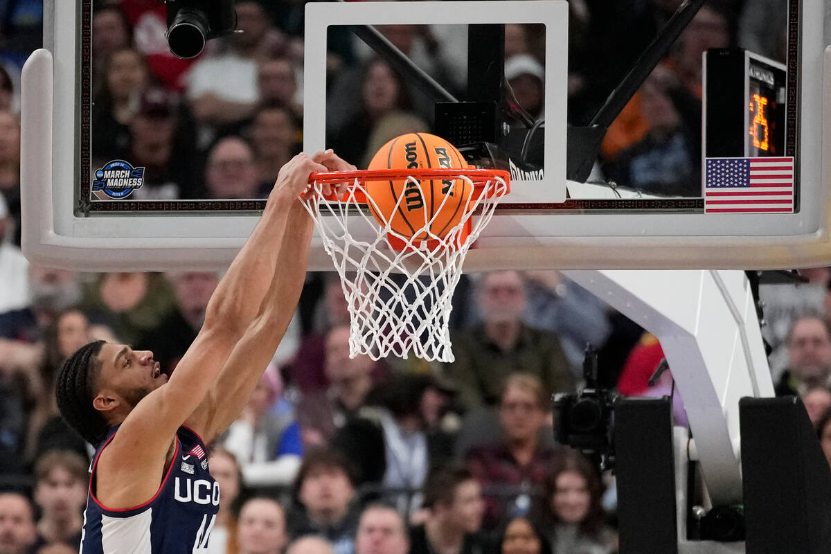 UConn guard Andre Jackson Jr. dunks in the first half of an Elite 8 college basketball game aga ...