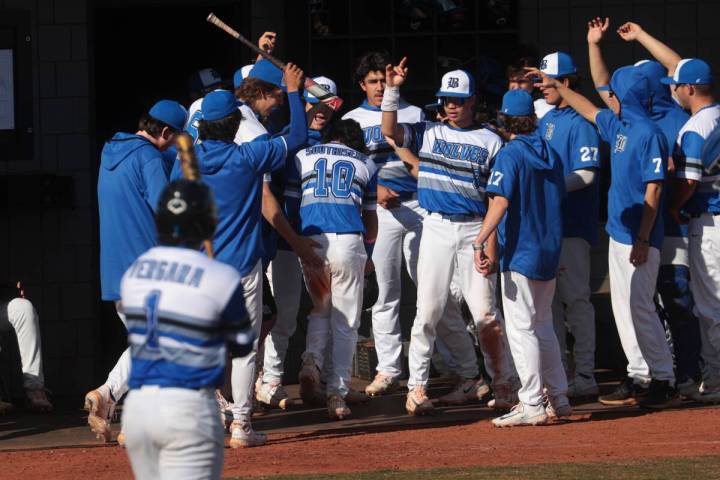 Basic players celebrate a run by Troy Southisene (10) during a baseball game against Green Vall ...