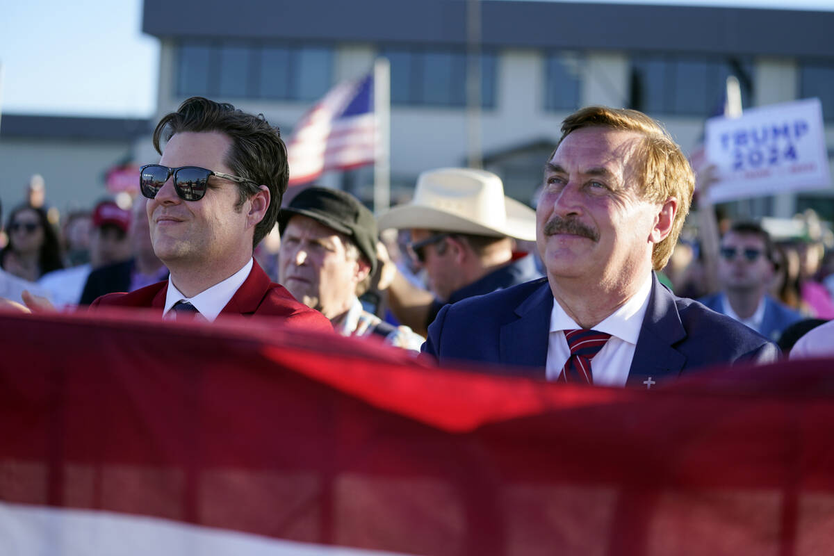 Rep. Matt Gaetz, R-Fla., left, and My Pillow CEO Mike Lindell listen as former President Donald ...